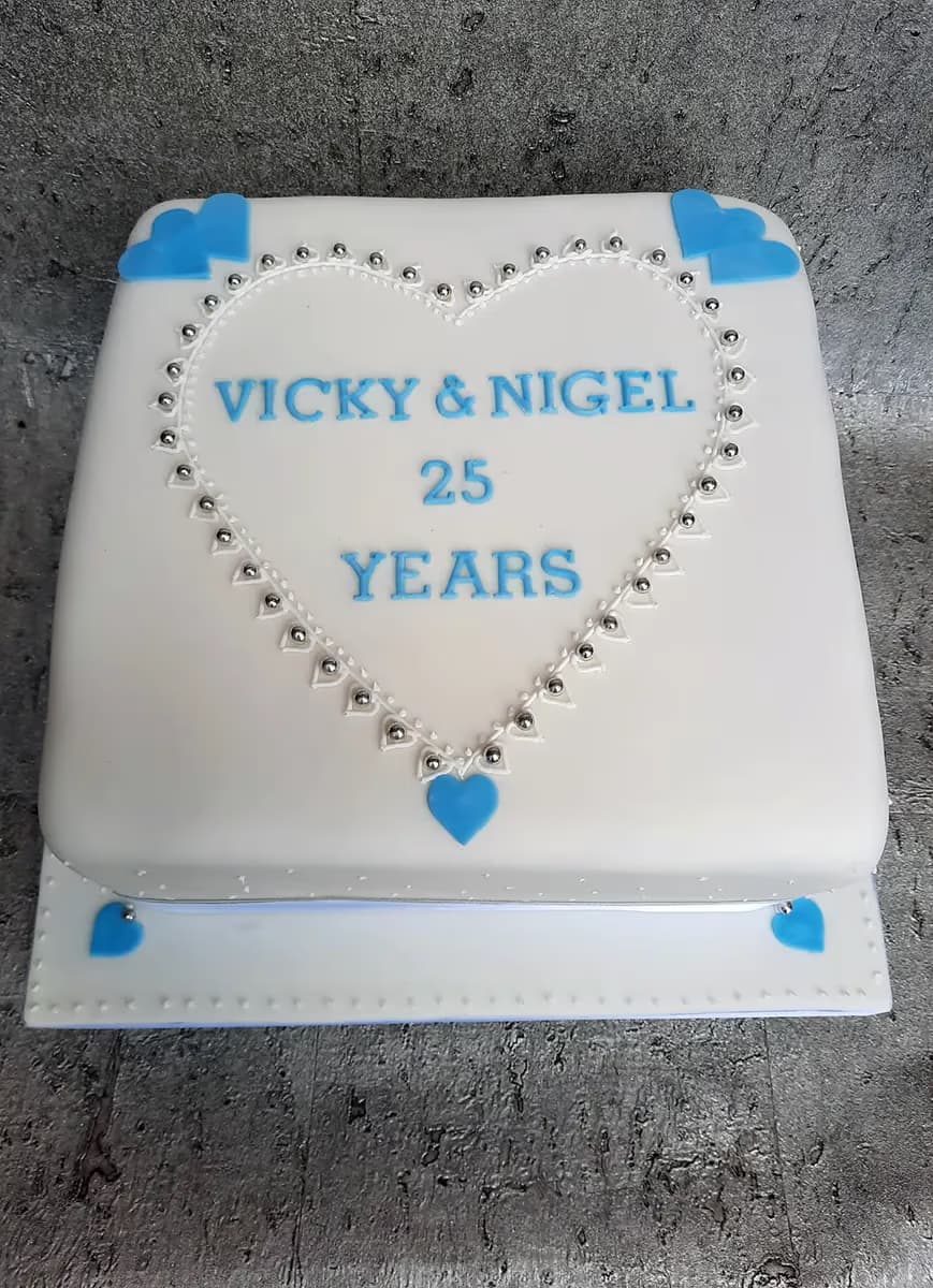 White and blue square anniversary cake with heart decoration for 25 years