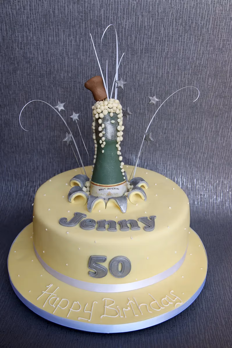 50th birthday cake with champagne bottle decoration