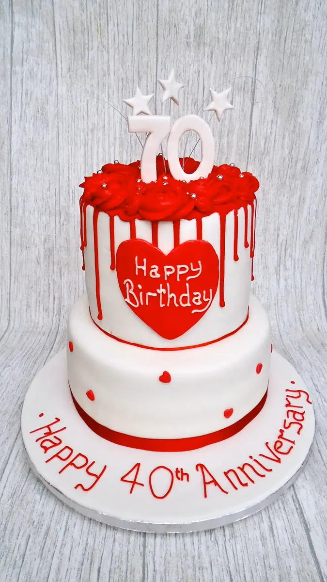 Two-tier white and red celebration cake for a 70th birthday and 40th anniversary