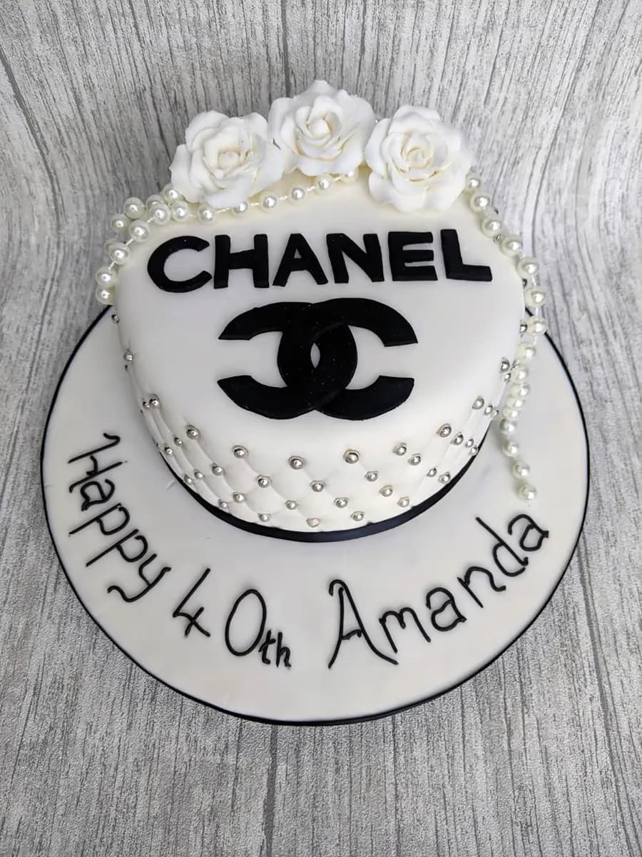 Chanel themed 40th birthday cake with white and black fondant, pearls, and roses
