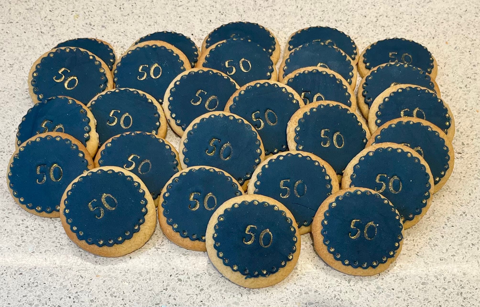 Navy and gold 50th birthday iced biscuits by Thelwall Bakehouse
