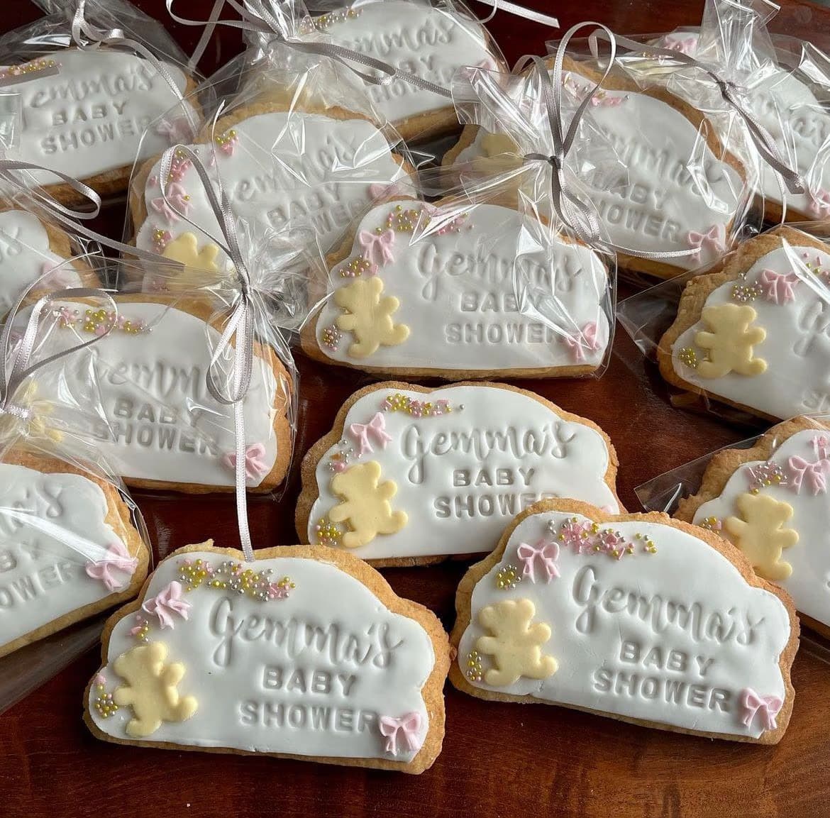 Handmade teddy bear baby shower iced biscuits with white icing and pink bows by Thelwall Bakehouse