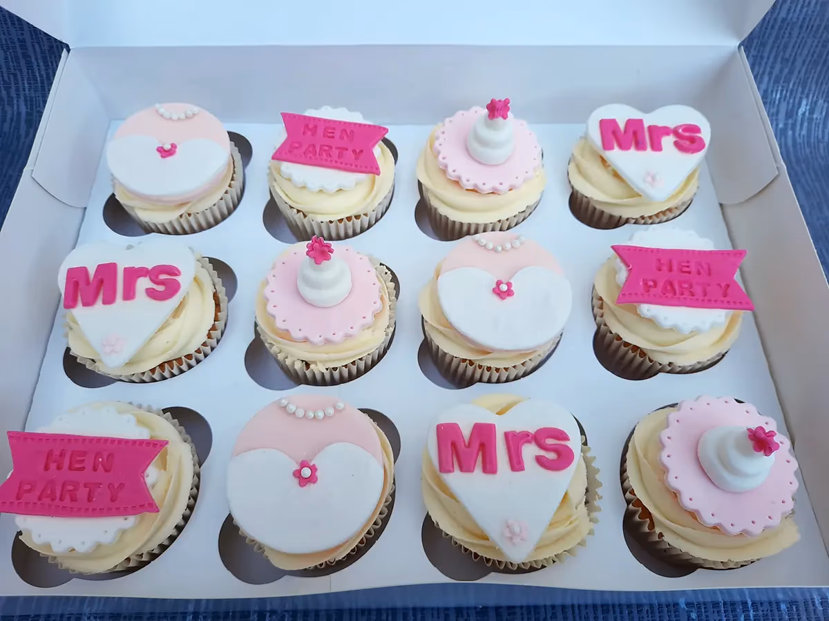 Pink and white bridal-themed hen party cupcakes by Thelwall Bakehouse