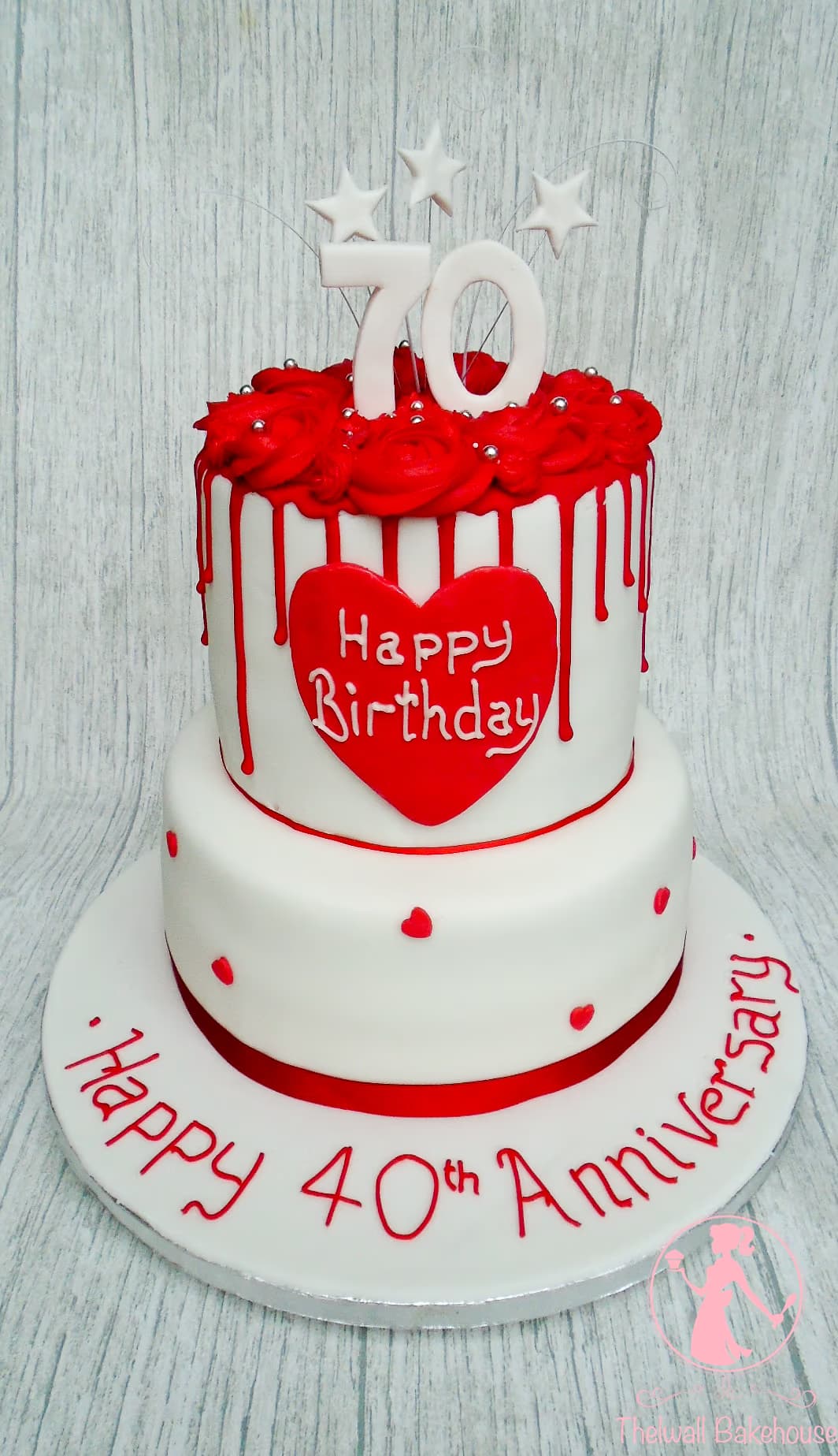 Two-tier 40th anniversary cake with white and red drip and roses