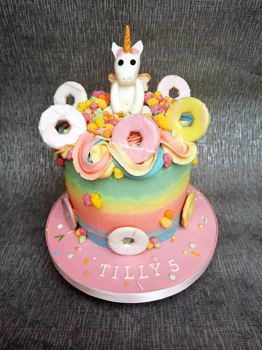 Unicorn birthday cake with rainbow mini donuts for Tilly's 5th birthday by Thelwall Bakehouse