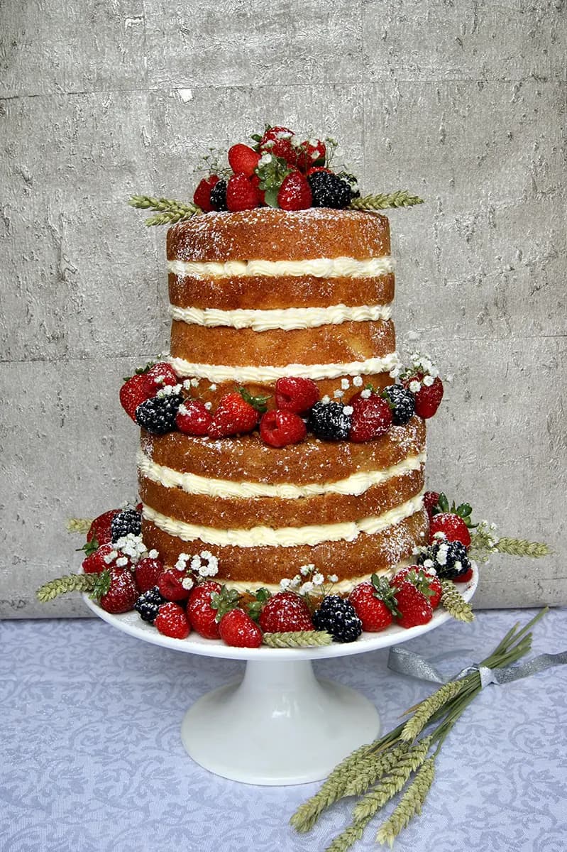 Pastel wedding cake with fresh flowers by Thelwall Bakehouse
