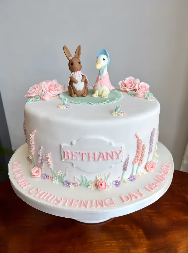Girl's christening cake with Peter Rabbit and Jemima Puddle-Duck decorations