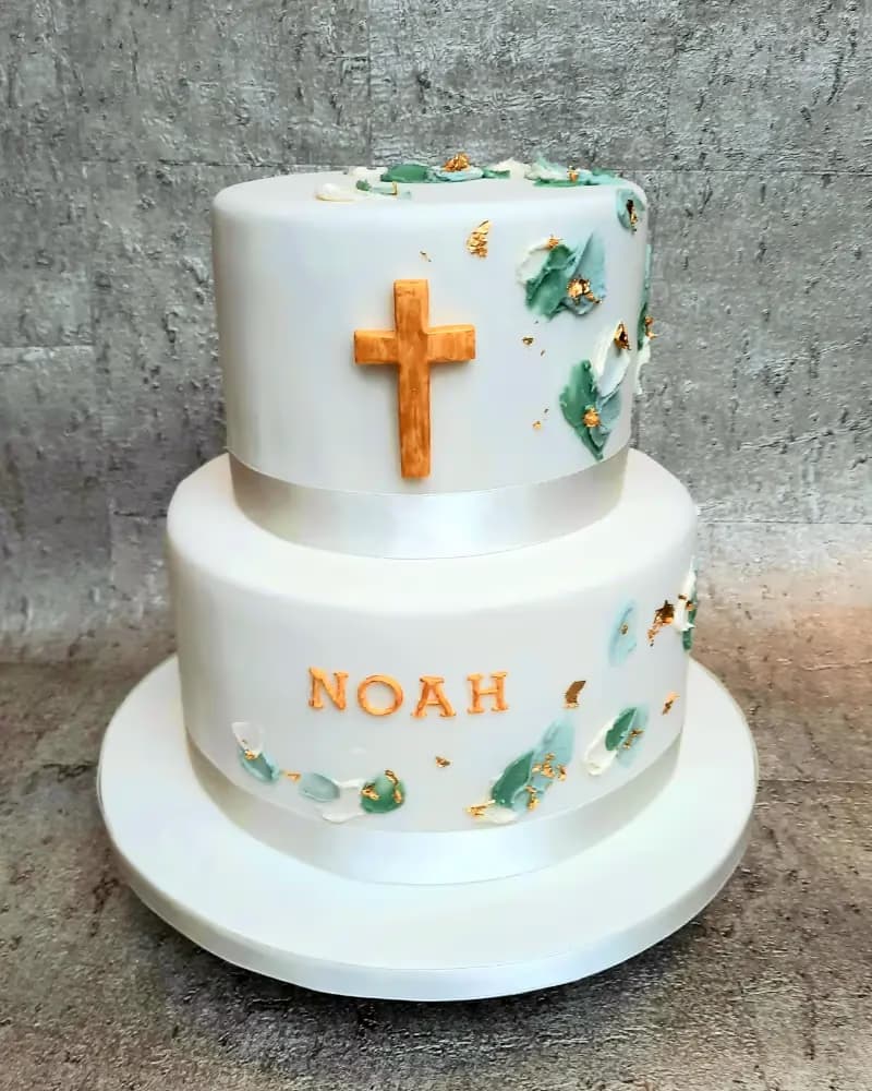 Two-tier white fondant christening cake with gold cross and name