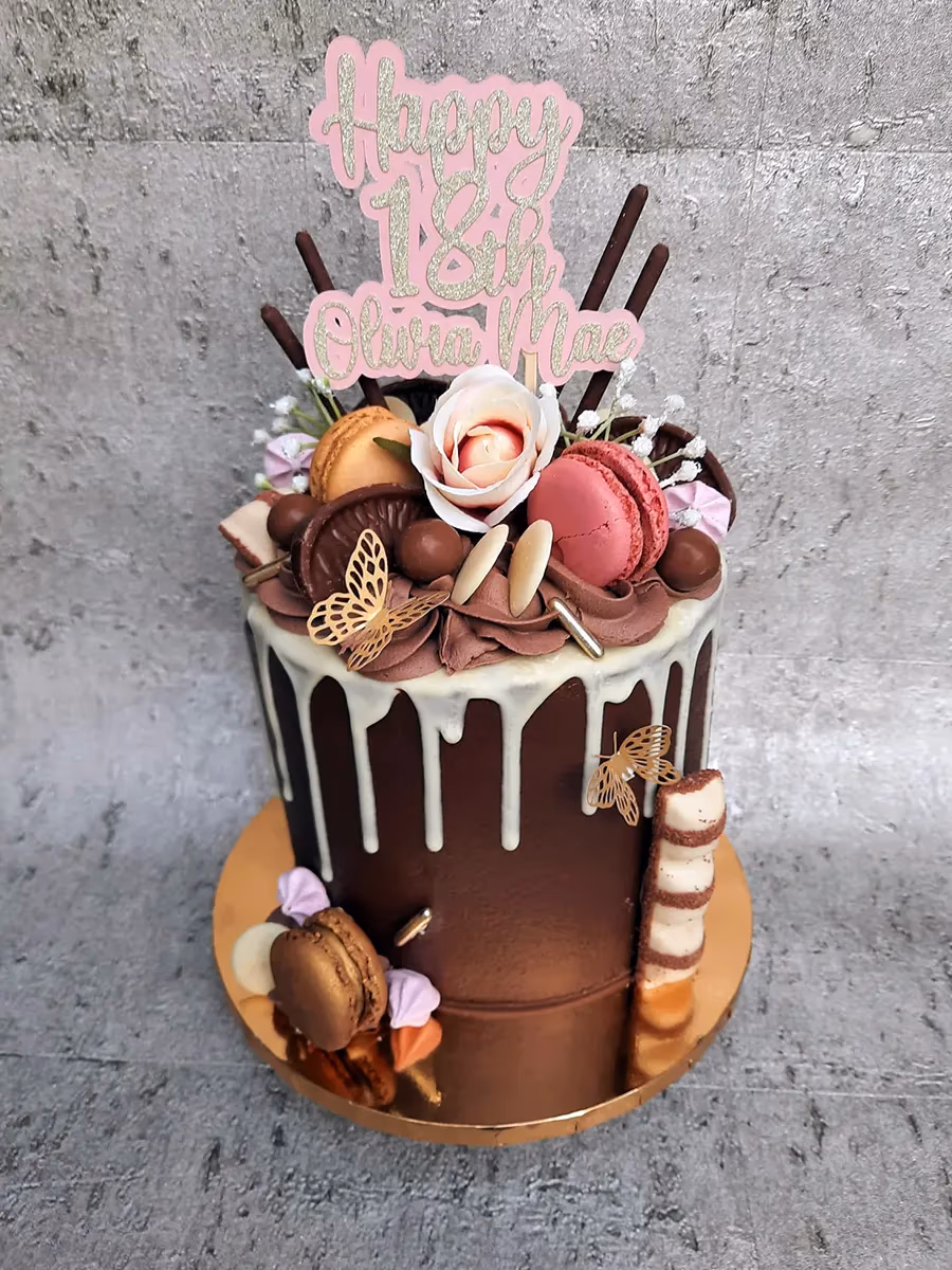 18th birthday chocolate drip cake with macarons and Kinder Bueno
