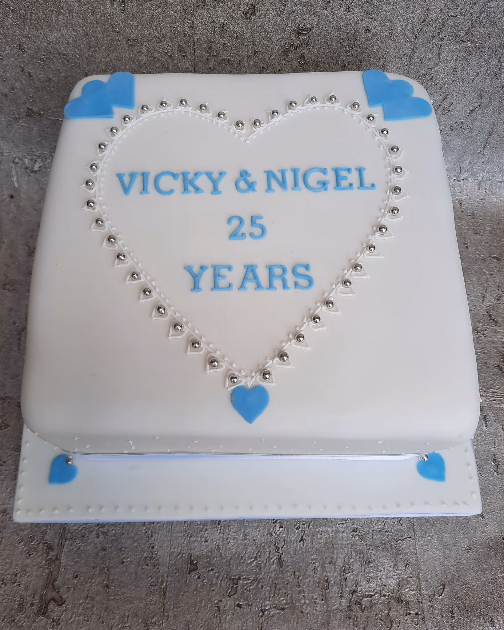 25th anniversary cake with white and blue hearts