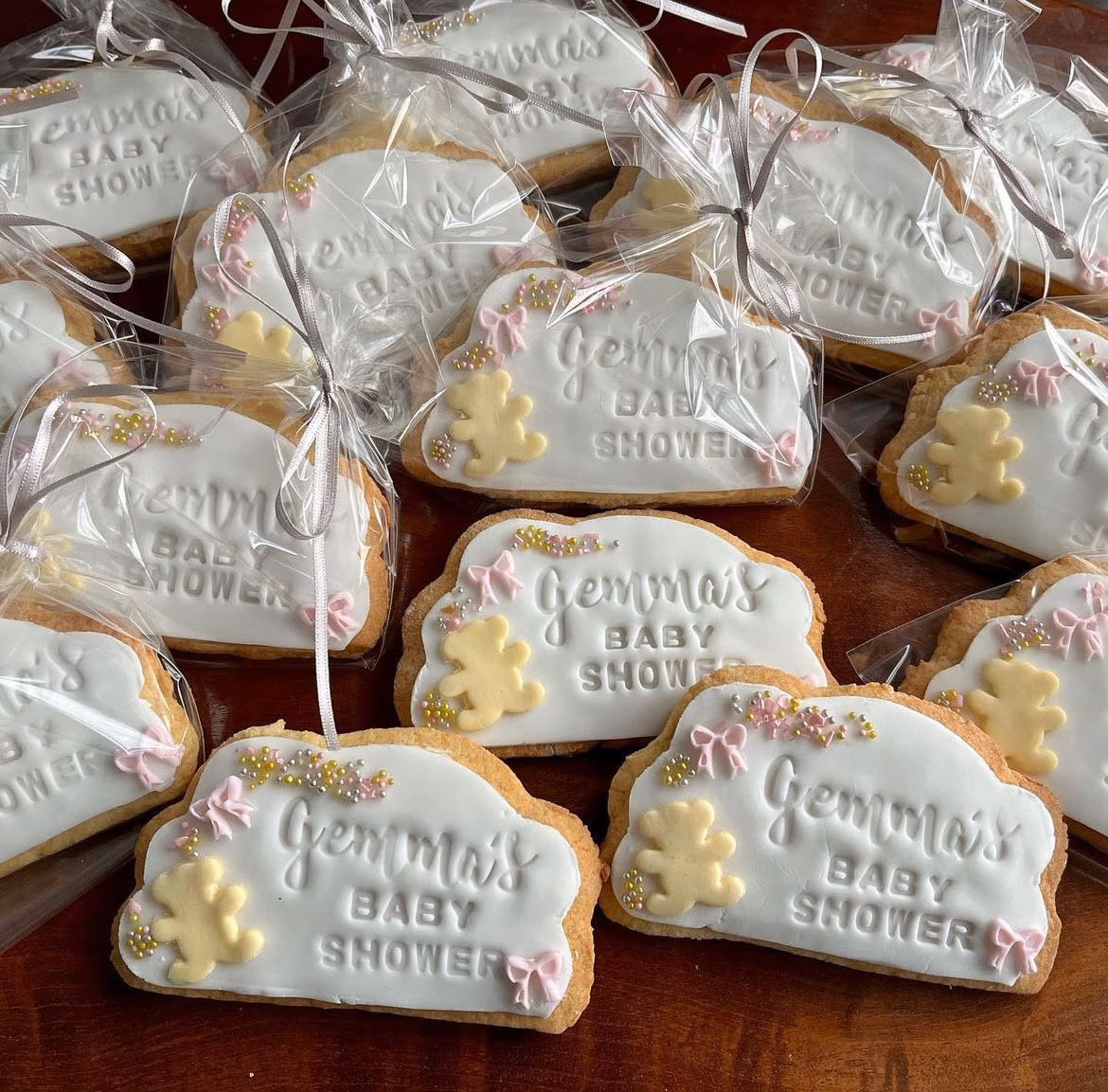 Handmade teddy bear baby shower iced biscuits with white icing and pink bows by Thelwall Bakehouse