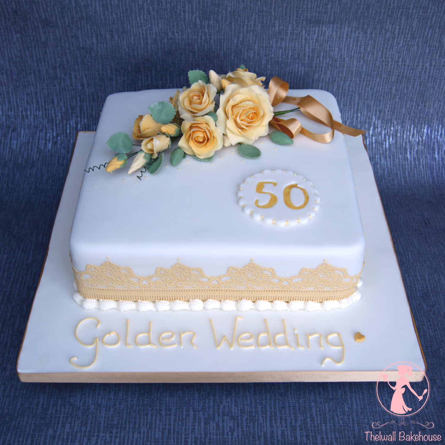 Square golden wedding cake with yellow roses for a 50th anniversary