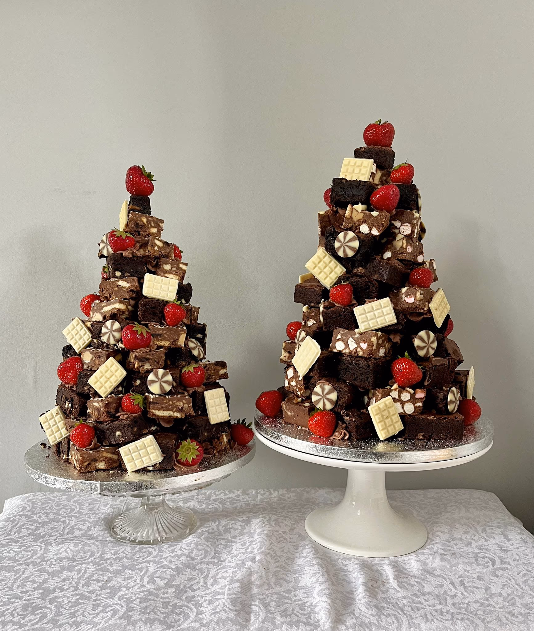 Two brownie stacks decorated with strawberries and white chocolate by Thelwall Bakehouse