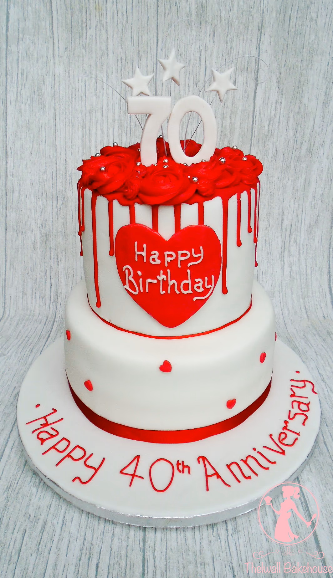 Two-tier 40th anniversary cake with white and red drip and roses