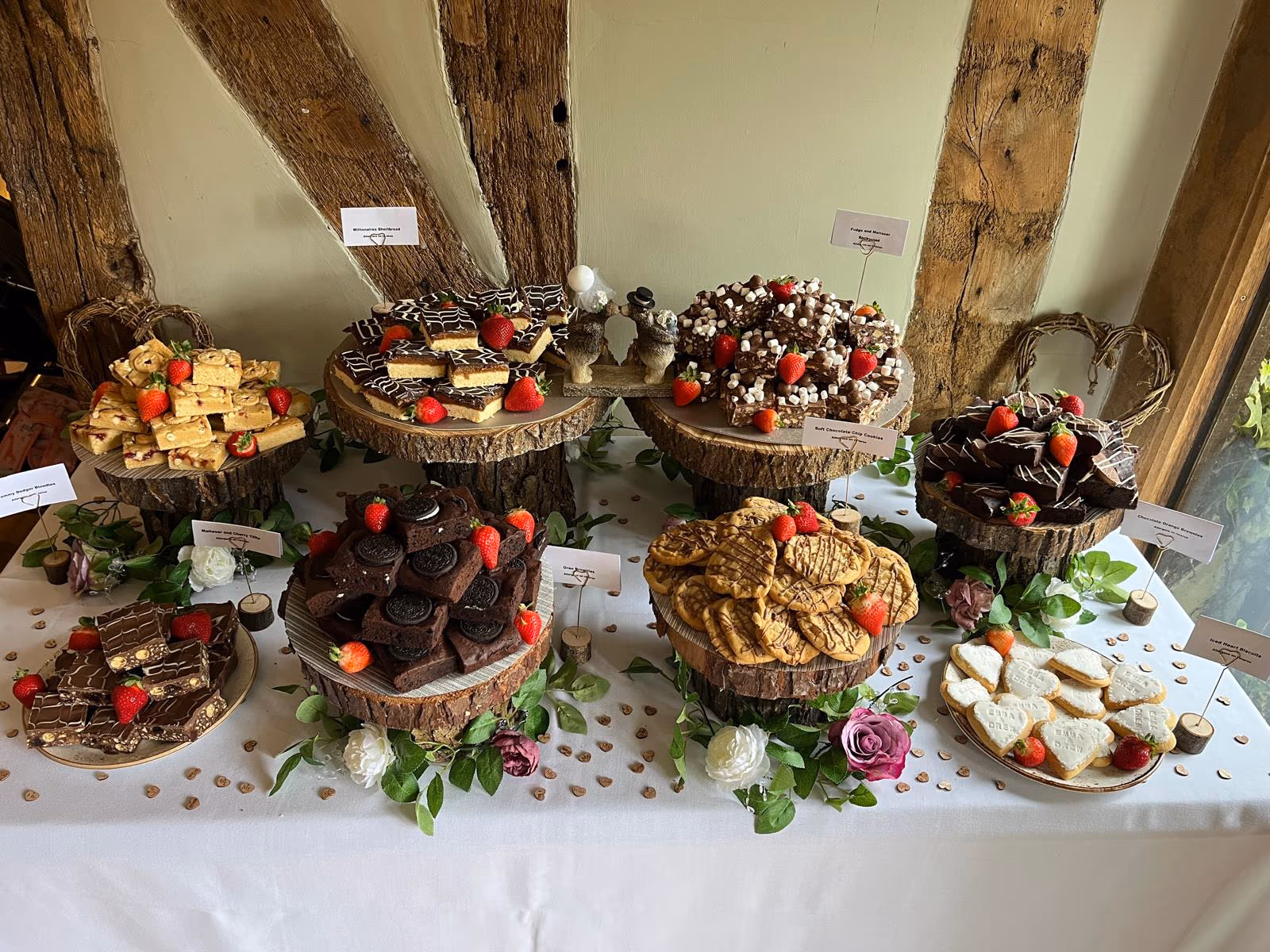Wedding dessert table with handmade brownies, blondies, cookies, and biscuits by Thelwall Bakehouse