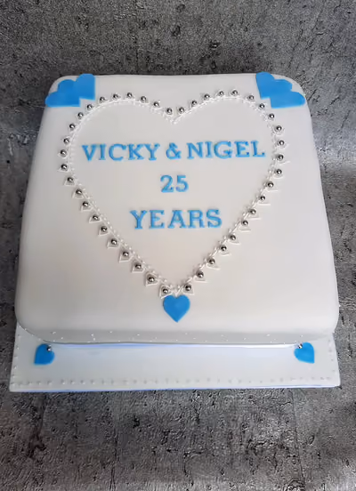 White and blue square anniversary cake with heart decoration for 25 years