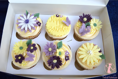 Floral pastel birthday cupcakes with butterfly decorations by Thelwall Bakehouse