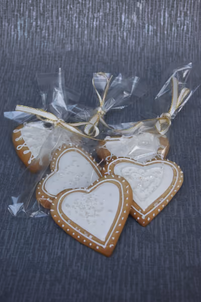 Handmade iced heart biscuits with white and gold decoration