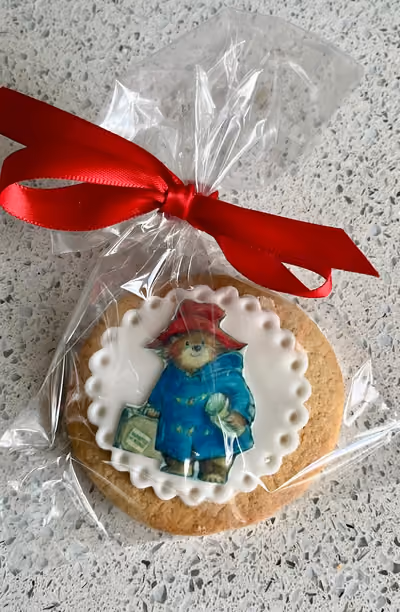 Individually wrapped Paddington Bear iced biscuit with red ribbon