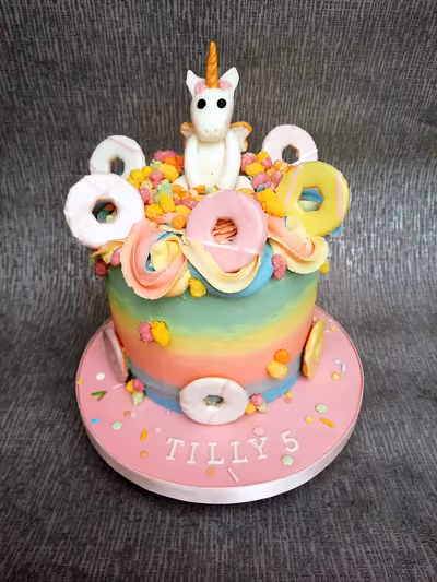 Unicorn birthday cake with rainbow mini donuts for Tilly's 5th birthday by Thelwall Bakehouse